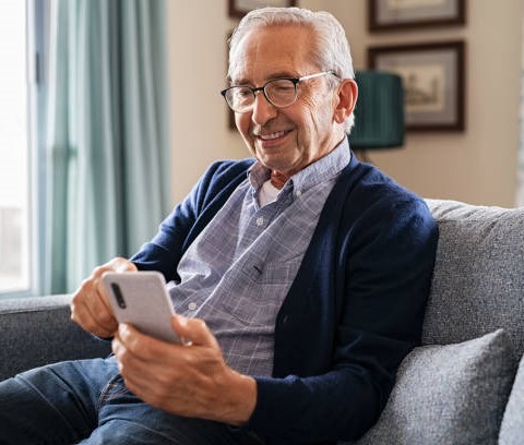 A Toothpicks staff member helping an elderly male fill out a form.